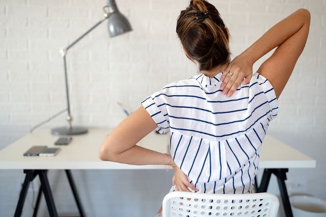 Woman working from home with back pain