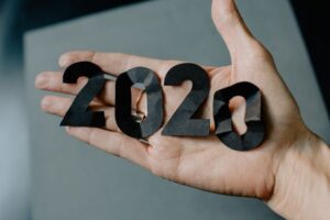 Hand with paper 2020 cut out on top