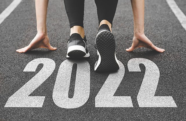 close-up of female feet in sneakers at the start. Beginning and start of the new year 2022, goals and plans for the next year
